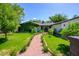 Charming home featuring lush greenery and a welcoming brick walkway at 4331 E Avalon Dr, Phoenix, AZ 85018