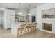 Bright kitchen featuring a marble island, modern appliances, and a cozy fireplace at 4331 E Avalon Dr, Phoenix, AZ 85018