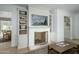 Cozy living room featuring a fireplace and built-in bookshelves at 4331 E Avalon Dr, Phoenix, AZ 85018