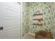 room featuring fun wallpaper, floating shelves with books, and cozy seating for reading at 4331 E Avalon Dr, Phoenix, AZ 85018