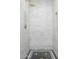 Elegant shower featuring marble tile, a gold shower head, and a built-in niche at 4331 E Avalon Dr, Phoenix, AZ 85018
