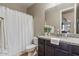 Cozy bathroom featuring a shower with curtain, vanity, and granite countertop at 4412 E Grand Canyon Dr, Chandler, AZ 85249