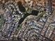 Aerial view of a neighborhood next to a golf course with ponds at 5022 E Magic Stone Dr, Phoenix, AZ 85044