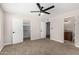 Cozy bedroom with neutral carpet, ceiling fan and access to closet and bathroom at 5022 E Magic Stone Dr, Phoenix, AZ 85044