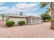 Rear view of the property, showcasing the desert landscaping and enclosed patio area at 5022 E Magic Stone Dr, Phoenix, AZ 85044