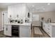 Bright kitchen featuring white cabinets, marble countertops, stainless steel appliances, and a built-in wine fridge at 5022 E Magic Stone Dr, Phoenix, AZ 85044