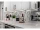 Kitchen counter featuring marble countertops, designer backsplash, and elegant decor at 5022 E Magic Stone Dr, Phoenix, AZ 85044