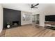 Bright living room featuring a black brick fireplace, a ceiling fan, and a sliding glass door at 5022 E Magic Stone Dr, Phoenix, AZ 85044