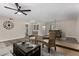 Spacious living room featuring woven chairs, a ceiling fan, and a view into the dining room at 5022 E Magic Stone Dr, Phoenix, AZ 85044