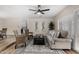 Open-concept living room with stylish furniture, neutral tones, and access to the dining and kitchen areas at 5022 E Magic Stone Dr, Phoenix, AZ 85044