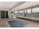 Bright sunroom featuring a patterned rug, screened windows, and access to the backyard at 5022 E Magic Stone Dr, Phoenix, AZ 85044