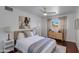 Bright bedroom featuring hardwood floors, a ceiling fan, and a large window with beautiful curtains at 5110 E Verde Ln, Phoenix, AZ 85018