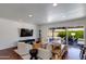 Bright living room with recessed lighting, stylish seating, and sliding glass doors opening to an outdoor pool area at 5110 E Verde Ln, Phoenix, AZ 85018