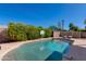 Sparkling pool surrounded by green hedges and a basketball hoop providing outdoor entertainment and relaxation at 5110 E Verde Ln, Phoenix, AZ 85018