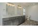 Bathroom featuring double sinks, modern lighting, and wood-look flooring at 5800 W Kesler St, Chandler, AZ 85226
