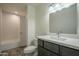 Bright bathroom featuring a shower-over-tub, a modern vanity, and gray cabinets at 5800 W Kesler St, Chandler, AZ 85226