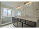 Bathroom featuring double sinks, modern lighting, and a glass-enclosed shower at 5800 W Kesler St, Chandler, AZ 85226