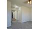 Bedroom featuring carpet, ceiling fan, and a view of the front door at 5800 W Kesler St, Chandler, AZ 85226