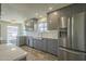 Kitchen featuring stainless steel appliances, white countertops, gray cabinets, and wood-look flooring at 5800 W Kesler St, Chandler, AZ 85226