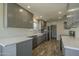 Modern kitchen with grey cabinets, white countertops, stainless steel appliances, and wood-look flooring at 5800 W Kesler St, Chandler, AZ 85226