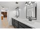 Modern bathroom featuring a dual sink vanity and stylish black and white dotted accent wall at 6105 N 12Th Way, Phoenix, AZ 85014