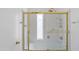 Bathroom showcasing a bathtub with white tile surround and sliding glass doors with gold trim at 6105 N 12Th Way, Phoenix, AZ 85014