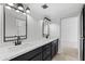 Updated bathroom features modern fixtures, dual sinks, and eye-catching wallpaper accents at 6105 N 12Th Way, Phoenix, AZ 85014