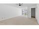 Spacious bedroom with neutral carpet, ceiling fan, and a sliding glass door to the patio at 6105 N 12Th Way, Phoenix, AZ 85014