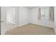 Neutral bedroom featuring carpet, a window with blinds, and an open doorway at 6105 N 12Th Way, Phoenix, AZ 85014