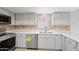 Kitchen with modern stainless-steel appliances and stone backsplash at 6105 N 12Th Way, Phoenix, AZ 85014