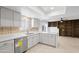Stylish kitchen features white cabinetry, sleek countertops, stainless steel appliances, and backyard access at 6105 N 12Th Way, Phoenix, AZ 85014