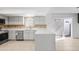 Bright kitchen featuring stainless steel appliances, white cabinetry, and an eye-catching tile backsplash at 6105 N 12Th Way, Phoenix, AZ 85014