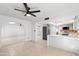 Open-concept living space with a ceiling fan and seamlessly connects to the modern kitchen area at 6105 N 12Th Way, Phoenix, AZ 85014