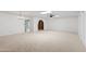 Spacious living room featuring neutral carpeting and arched doorway at 6105 N 12Th Way, Phoenix, AZ 85014