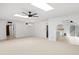 Bright and airy living area with ceiling fan, skylights, and seamless access to a modern kitchen at 6105 N 12Th Way, Phoenix, AZ 85014