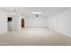 Large living room with built-in shelving, carpeted floors, and a ceiling fan at 6105 N 12Th Way, Phoenix, AZ 85014