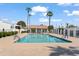 Community pool with cabana and palm trees under a clear blue sky at 6105 N 12Th Way, Phoenix, AZ 85014