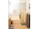Bathtub with a glass enclosed shower and light wood cabinets in a well-lit bathroom at 7024 W Tether Trl, Peoria, AZ 85383