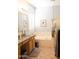 Bright bathroom with a large tub, granite countertops, and neutral tile flooring at 7024 W Tether Trl, Peoria, AZ 85383