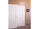 Bedroom closet with white doors and a gold handle at 7024 W Tether Trl, Peoria, AZ 85383