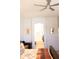 Cozy bedroom with a ceiling fan and an arched entryway to the bathroom at 7024 W Tether Trl, Peoria, AZ 85383