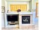 Living room with a fireplace, built-in shelving, tiled hearth, and shuttered windows at 7024 W Tether Trl, Peoria, AZ 85383
