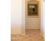 Hallway with tan flooring and a framed painting at 7024 W Tether Trl, Peoria, AZ 85383