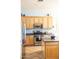 Kitchen features stainless steel appliances, wooden cabinetry, and tile flooring at 7024 W Tether Trl, Peoria, AZ 85383