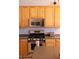 Kitchen with stainless steel appliances and light wood cabinetry at 7024 W Tether Trl, Peoria, AZ 85383