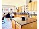 Open kitchen with stainless steel appliances, a large island, light wood cabinets, and great natural light at 7024 W Tether Trl, Peoria, AZ 85383