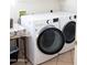 Laundry room featuring modern, front-load washing and drying machines at 7024 W Tether Trl, Peoria, AZ 85383