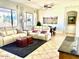 Bright living room featuring neutral colors, tile floor, large windows, and comfortable seating arrangement at 7024 W Tether Trl, Peoria, AZ 85383