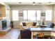 Inviting living room with a fireplace, large windows, and comfortable seating at 7024 W Tether Trl, Peoria, AZ 85383