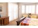 Bright main bedroom featuring shutters on the windows, chairs, and a decorative bed spread at 7024 W Tether Trl, Peoria, AZ 85383